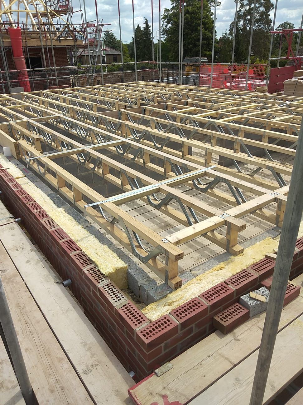 New-build apartment substructure in St Albans, Posi-joist ground floor installed over a cavity wall with full-fill insulation and perpend air bricks