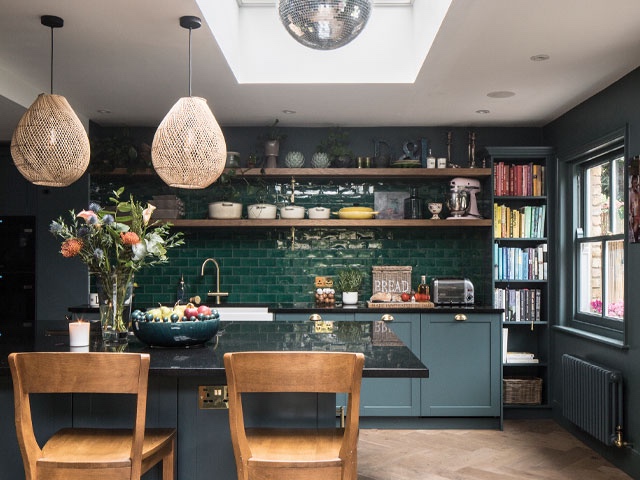 New Balham kitchen, deep-teal Shaker cabinetry, green glazed tile splashback, dark stone worktop and brass fittings