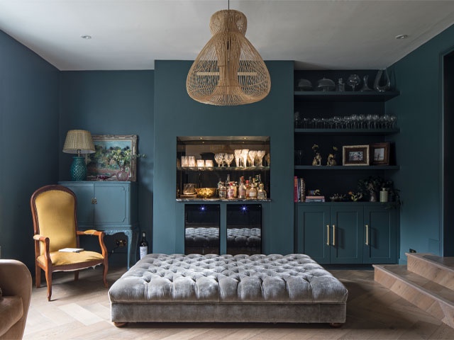 Snug area at Balham property, walls redecorated in deep teal with built-in joinery and herringbone flooring